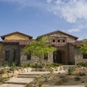 Exterior view of residence which was built by estate, hacienda, historic site, home, house, landscape, mansion, property, real estate, sky, villa, brown, teal
