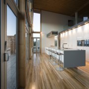 View of a kitchen designed by NKBA designer apartment, architecture, daylighting, floor, flooring, hardwood, house, interior design, loft, real estate, wood, wood flooring, brown