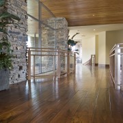 View of a hallway of this home which apartment, architecture, ceiling, daylighting, floor, flooring, hardwood, home, interior design, laminate flooring, lobby, real estate, wood, wood flooring, brown