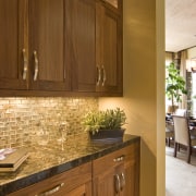 View of kitchen which features sold granite countertops cabinetry, countertop, cuisine classique, floor, flooring, hardwood, home, interior design, kitchen, room, under cabinet lighting, wood, wood flooring, wood stain, brown