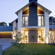 Exterior view of a high-end home which features architecture, building, cottage, elevation, facade, home, house, property, real estate, residential area, siding, sky, window, teal