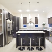 View of a kitchen which features dark stained cabinetry, countertop, cuisine classique, interior design, kitchen, real estate, room, white