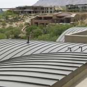 View of the Sun West Custom Home's metal architecture, daylighting, outdoor structure, property, real estate, roof, gray, brown