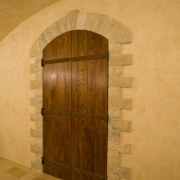 View of a wine cellar which features limestone arch, architecture, door, property, wall, wood, orange, brown