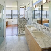 View of a bathroom which features a marble bathroom, countertop, floor, flooring, glass, interior design, real estate, room, tile, window, gray