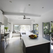 View of the kitchen featuring island, quartz counters, countertop, house, interior design, kitchen, real estate, gray