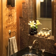 View of a powder room which features a bathroom, countertop, flooring, interior design, kitchen, lighting, room, wall, brown, orange