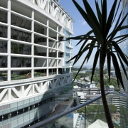 Exterior view of the Fusionopolis commercial/residential tower which architecture, arecales, building, condominium, corporate headquarters, metropolitan area, mixed use, reflection, structure, tourist attraction, tree, water, black