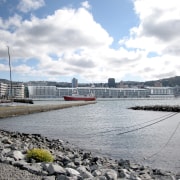 Exterior view of the Wellington Overseas Passenger Terminal boat, cloud, dock, marina, port, river, sky, water, water transportation, waterway, gray, white