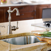 View of a kitchen which features faucets from countertop, kitchen, plumbing fixture, product design, sink, tap, white, brown