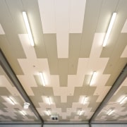 View of the Tupuranga School gymnasium which features ceiling, daylighting, daytime, light, lighting, line, gray