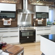 View of a contemporary kitchen which features a cabinetry, countertop, cuisine classique, home appliance, interior design, kitchen, kitchen appliance, kitchen stove, small appliance, white