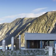 Exterior view of Te Kopahou Reserve Interpretation Centre architecture, cottage, elevation, home, house, hut, mountain, mountain range, real estate, sky, winter, teal