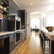 View of a kitchen which features kitchen cabinetry cabinetry, countertop, cuisine classique, floor, flooring, hardwood, interior design, kitchen, room, wood flooring, white, black