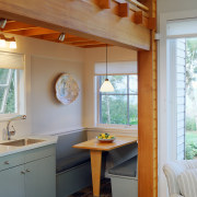 View of a small kitchen area adjacent to architecture, cabinetry, ceiling, countertop, daylighting, home, house, interior design, kitchen, real estate, room, table, window, wood, gray, brown