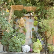 Exterior view of the outdoor area featuring slate backyard, courtyard, flower, garden, home, house, outdoor structure, plant, property, tree, brown, green