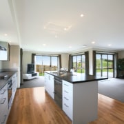 View of open-plan kitchen and dining area of countertop, floor, flooring, hardwood, interior design, kitchen, property, real estate, room, window, wood flooring, gray