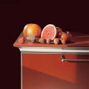 View of a contemporary kitchen which features countertops orange, still life, still life photography, table, red