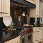 Designer Jennifer Gilmer, CKD, specified two islands for cabinetry, countertop, cuisine classique, home appliance, interior design, kitchen, kitchen appliance, kitchen stove, orange, black