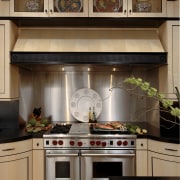 Designer Jennifer Gilmer, CKD, specified two islands for cabinetry, countertop, cuisine classique, home appliance, interior design, kitchen, kitchen stove, room, brown