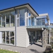 Exterior view of a Cliff top house, Features building, elevation, facade, home, house, mixed use, property, real estate, siding, window