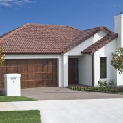 Exterior view of home featuring brick cladding, doors building, cottage, elevation, estate, facade, home, house, property, real estate, residential area, roof, white