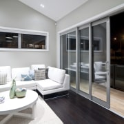 View of the main living area of this interior design, living room, real estate, window, gray, black, white