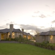 Exterior View of a home designed and Built cloud, cottage, estate, evening, facade, farmhouse, grass, home, house, landscape, mansion, morning, property, real estate, residential area, roof, sky, suburb, sunlight, white, brown