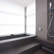 interior bathroom view of oak manor. Design by bathroom, daylighting, floor, interior design, plumbing fixture, room, tile, window, white, gray, black