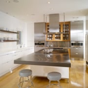 View of a condominium kitchen which features a cabinetry, countertop, cuisine classique, interior design, interior designer, kitchen, real estate, room, gray