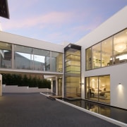 Exterior view of house designed by Graham Jones apartment, architecture, building, condominium, estate, facade, home, house, mixed use, property, real estate, residential area, window, gray