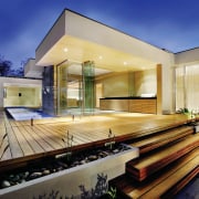 Exterior view of a new home built by architecture, estate, facade, home, house, lighting, property, real estate, residential area