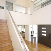 interior stairs view of a new home in architecture, ceiling, daylighting, floor, flooring, handrail, hardwood, home, house, interior design, laminate flooring, property, real estate, stairs, wall, window, wood, wood flooring, white