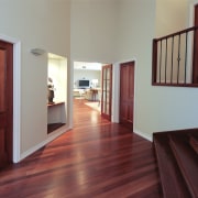 Interior stairway view of a remodelled house. Designed door, estate, floor, flooring, hardwood, home, house, interior design, laminate flooring, property, real estate, room, window, wood, wood flooring, wood stain, red, gray