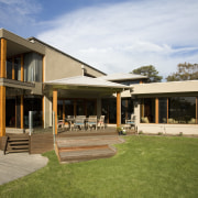 exterior view of a residence which was designed backyard, cottage, elevation, estate, facade, farmhouse, home, house, property, real estate, residential area, siding, villa, window, brown