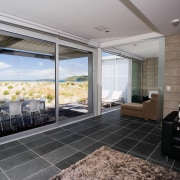 Exterior view of a new home built by architecture, daylighting, door, floor, glass, house, interior design, real estate, window, gray, black