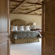 View of the master bedroom featuring a custom architecture, bed, bed frame, bedroom, ceiling, floor, flooring, furniture, home, interior design, room, wall, wood, wood flooring, brown, gray