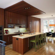 View of a kitchen which features a kitchen cabinetry, countertop, cuisine classique, floor, flooring, hardwood, interior design, kitchen, real estate, room, wood, wood flooring, gray, brown