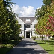 View of the homes exterior featuring stained cider architecture, autumn, building, campus, cottage, estate, farmhouse, garden, grass, home, house, landscape, leaf, mansion, nature, neighbourhood, plant, plantation, property, real estate, residential area, sky, spring, suburb, tree, woody plant, brown