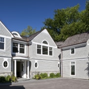 View of the homes exterior featuring stained cider building, cottage, elevation, estate, facade, farmhouse, historic house, home, house, mansion, neighbourhood, property, real estate, residential area, roof, siding, suburb, window, white