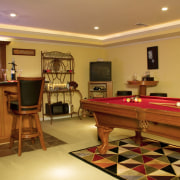View of basement entertainment area featuring pool table billiard room, floor, flooring, interior design, recreation room, room, table, brown, orange