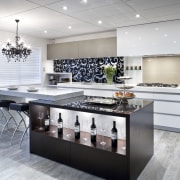 This kitchen by Yellowfox features an island with countertop, cuisine classique, floor, flooring, interior design, kitchen, room, gray, white