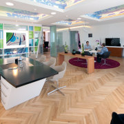 The new Zain headquarters in Bahrain reflects the floor, flooring, interior design, lobby, gray, orange