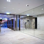 The woven wicker and teak furniture on this ceiling, floor, flooring, glass, interior design, lobby, gray