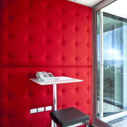 The office interiors at the Club Tower reflect architecture, ceiling, interior design, office, product design, red, table, wall, red