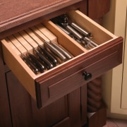 This kitchen features compartmentalized storage solutions.This kitchen features drawer, furniture, wood stain, brown