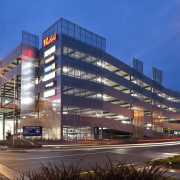 View of the Westfield Riccarton carpark. - View architecture, building, city, commercial building, condominium, corporate headquarters, headquarters, hotel, landmark, metropolis, metropolitan area, mixed use, night, real estate, residential area, sky, urban area, blue