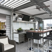 The commercial look of the kitchen is reinforced interior design, real estate, roof, white, gray, black