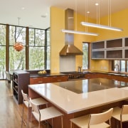 View of the kitchen featuring wenge and mahogany architecture, cabinetry, countertop, dining room, hardwood, interior design, kitchen, real estate, room, brown, orange