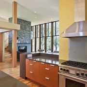 View of the kitchen featuring wenge and mahogany cabinetry, countertop, estate, floor, flooring, hardwood, interior design, kitchen, property, real estate, room, wood flooring, gray, orange